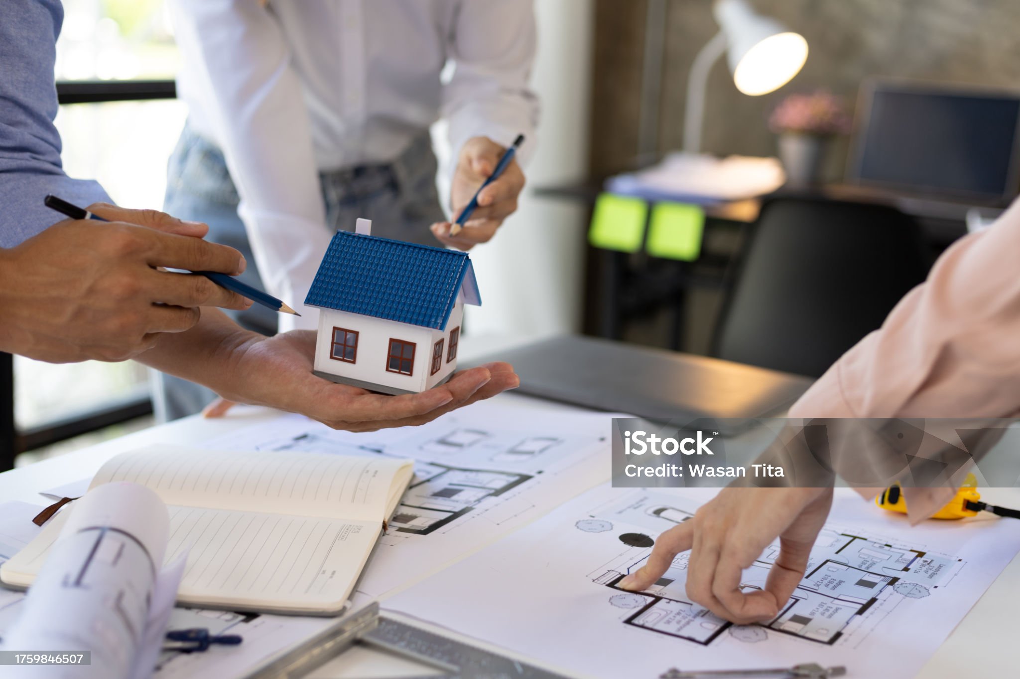 Group of young architects colleagues brainstorm design work on blueprint planning ideas of construction projects. Construction engineering design inspector team working in the office.