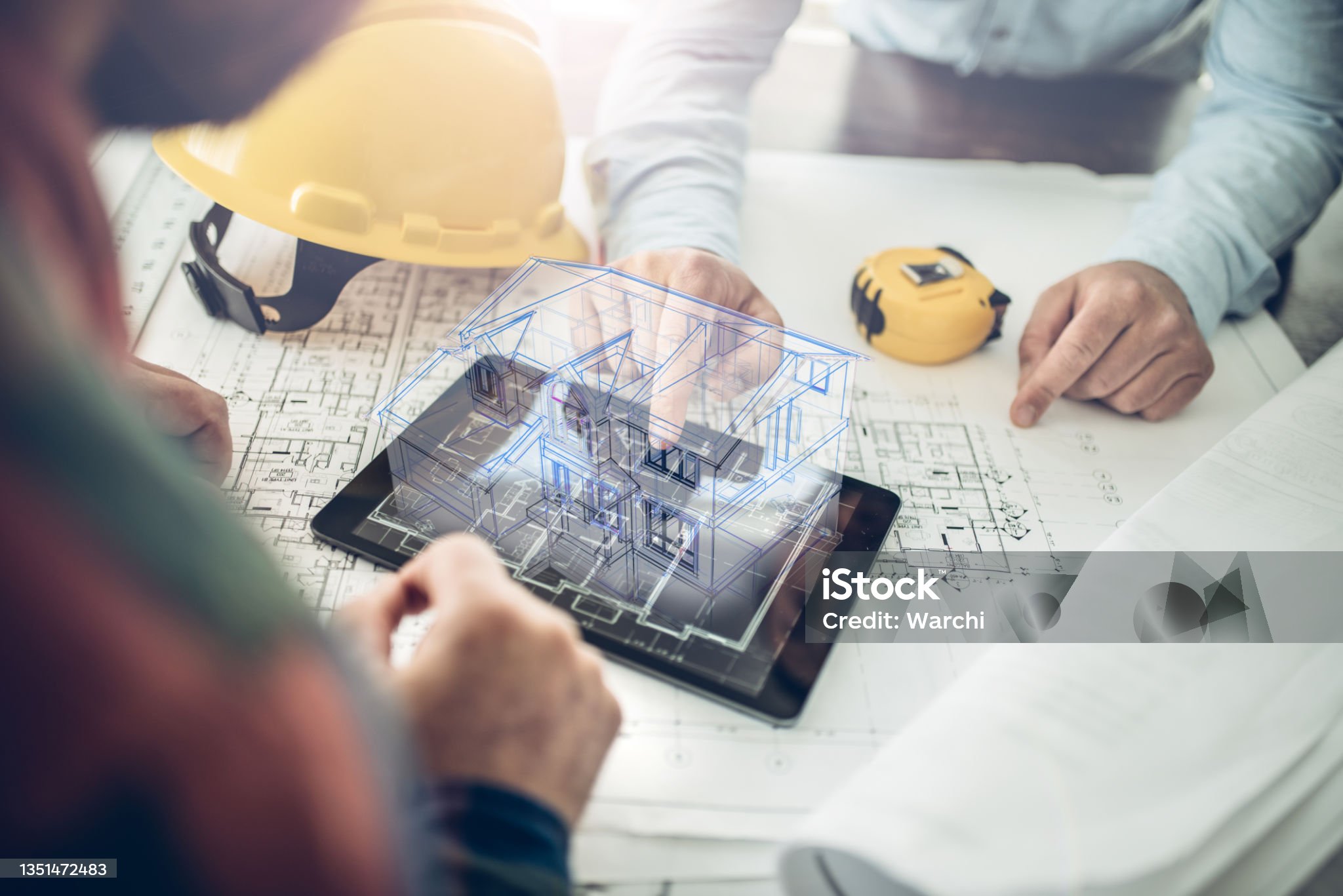 Architect and his client looking at the hologram of a house project over a tablet computer. The client is reviewing his future house layout
Note to inspector: I am the author of the building project